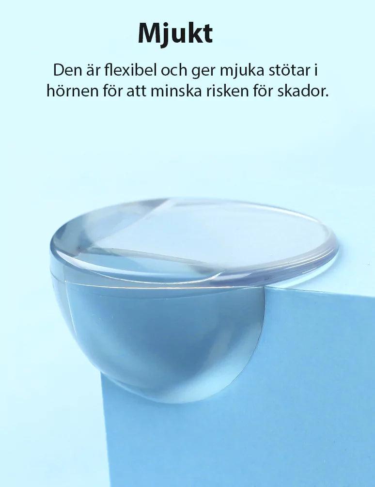 Mjukt transparent hörnskydd i flexibel silikon monterat på bordshörna för att minska skaderisk.