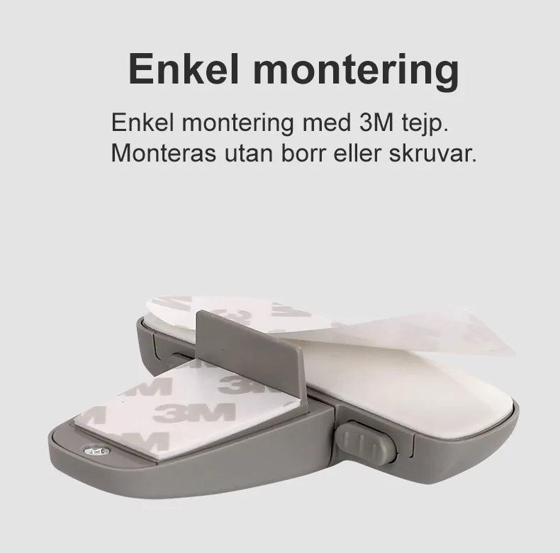 Barnlås för kylskåp med 3M-tejp visas i närbild, redo för enkel montering utan borr eller skruvar.