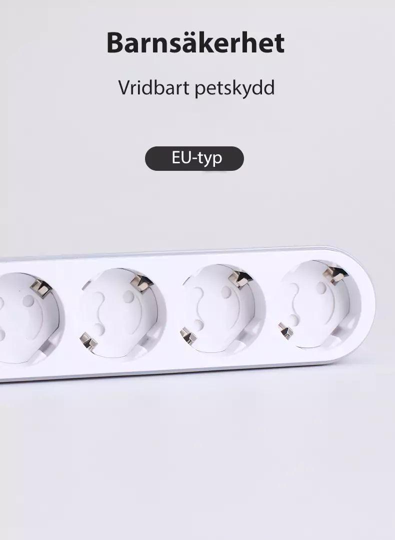 Vitt grenuttag med vridbara barnsäkra petskydd i varje EU-eluttag, med texten ‘Barnsäkerhet – Vridbart petskydd, EU-typ’ ovanför